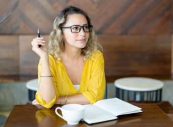 pretty-curly-young-woman-writing-notes-startup-project